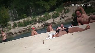 Naked babes spreading their pussies on the beach